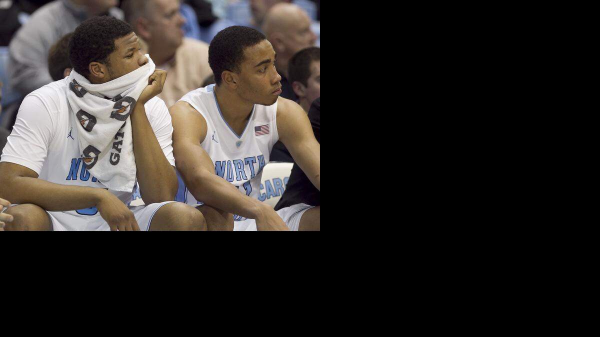 
UNC's Kennedy Meeks and Brice Johnson watch the closing minute of play from the bench as Miami defeats the Tar Heels 63-57 at the Smith Center in Chapel Hill.