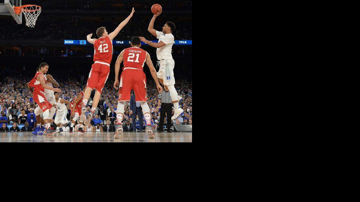 
Duke center Jahlil Okafor  shoots over Utah forward Jakob Poeltl (42) in the second half. Duke defeated Utah 63-57 on Friday in the semifinal of the NCAA South Region at the NRG Stadium in Houston.
