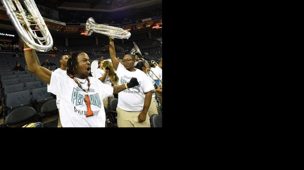 
Livingstone pep band members David Draper, left, and Monique Thomas, right, both juniors from Detroit, hold up their euphoniums as they cheer on their team Tuesday.  The Blue Bears defeated Bowie State 91-73 during the first round of the women's CIAA tournament at Time Warner Cable Arena on Tuesday.
