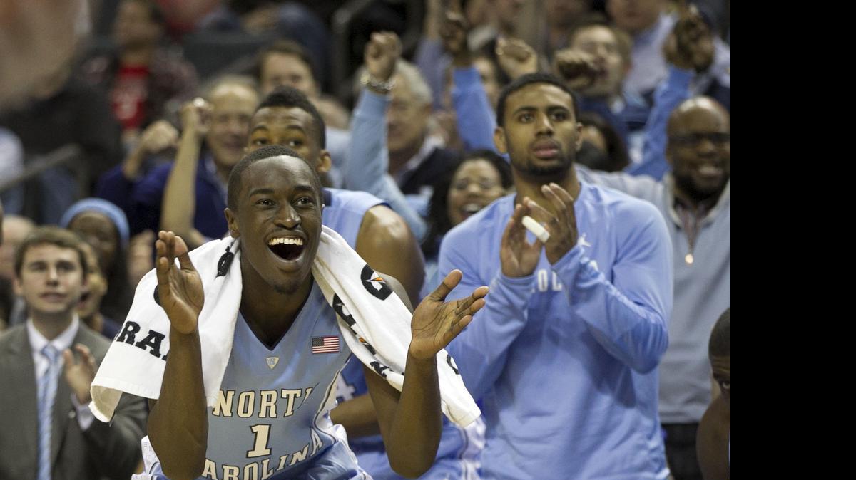 
UNC's Theo Pinson (1) celebrates a dunk by teammate Kennedy Meeks (3) during the second half against Davidson on November 22, 2014 at the Time Warner Cable Arena in Charlotte. Pinson underwent surgery on his left foot on Monday.
