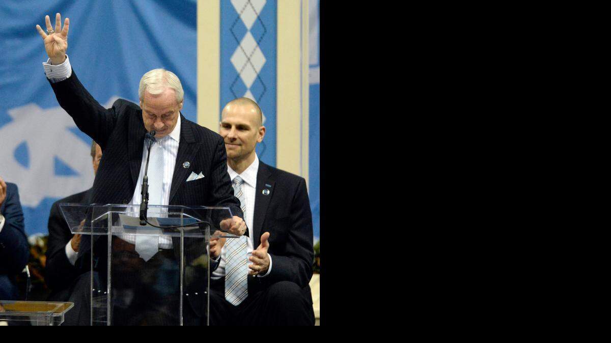 
North Carolina basketball coach Roy Williams gives the signal for "Four Corners" in honor of Dean Smith during a memorial service for the legendary coach Sunday at UNC Chapel Hill.


