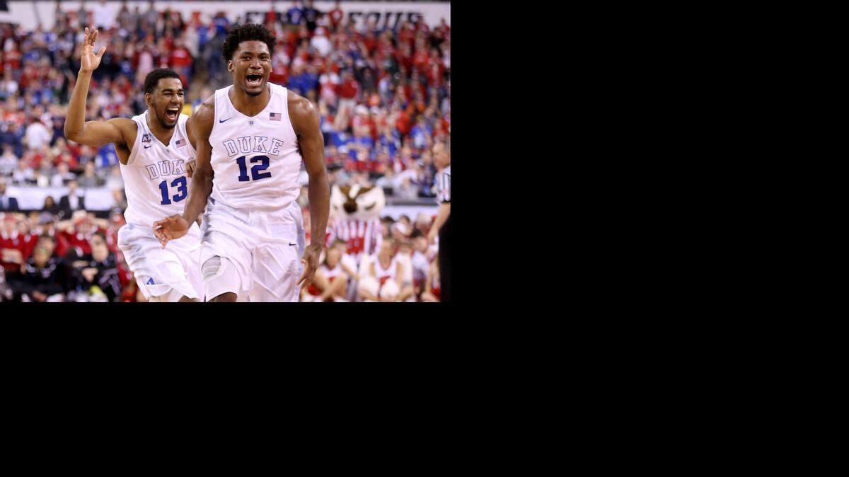 
Matt Jones, left, and Justise Winslow celebrate the Blue Devils’ 68-68 victory Monday night against Wisconsin for the national championship. 
