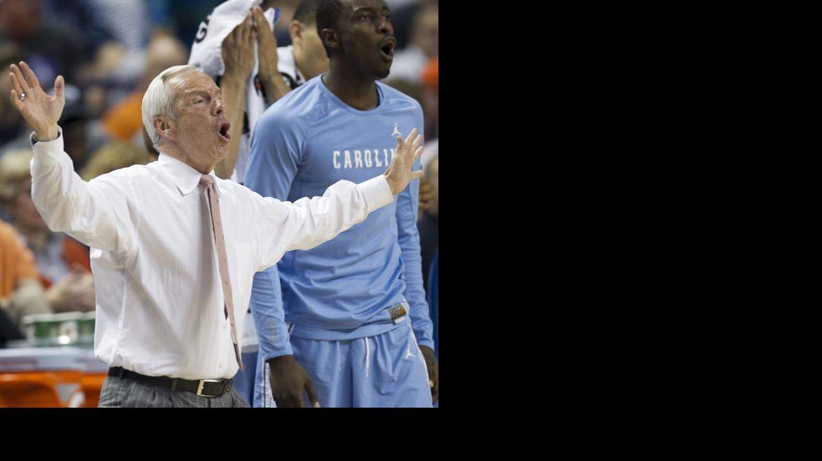 
North Carolina coach Roy Williams directs his team on defense during the first half against Louisville  during the quarterfinals of the Atlantic Coast Conference Basketball Tournament at the Greensboro Coliseum.
