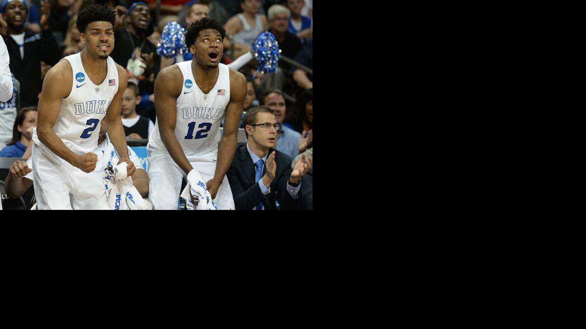 
Duke guard Quinn Cook (2) and teammate Duke forward Justise Winslow (12) react to a teammate’s shot in the closing minute of the game as the Blue Devils defeated No. 16 seed Robert Morris 85-56 at the Time-Warner Cable Arena in Charlotte, March 20, 2015.
