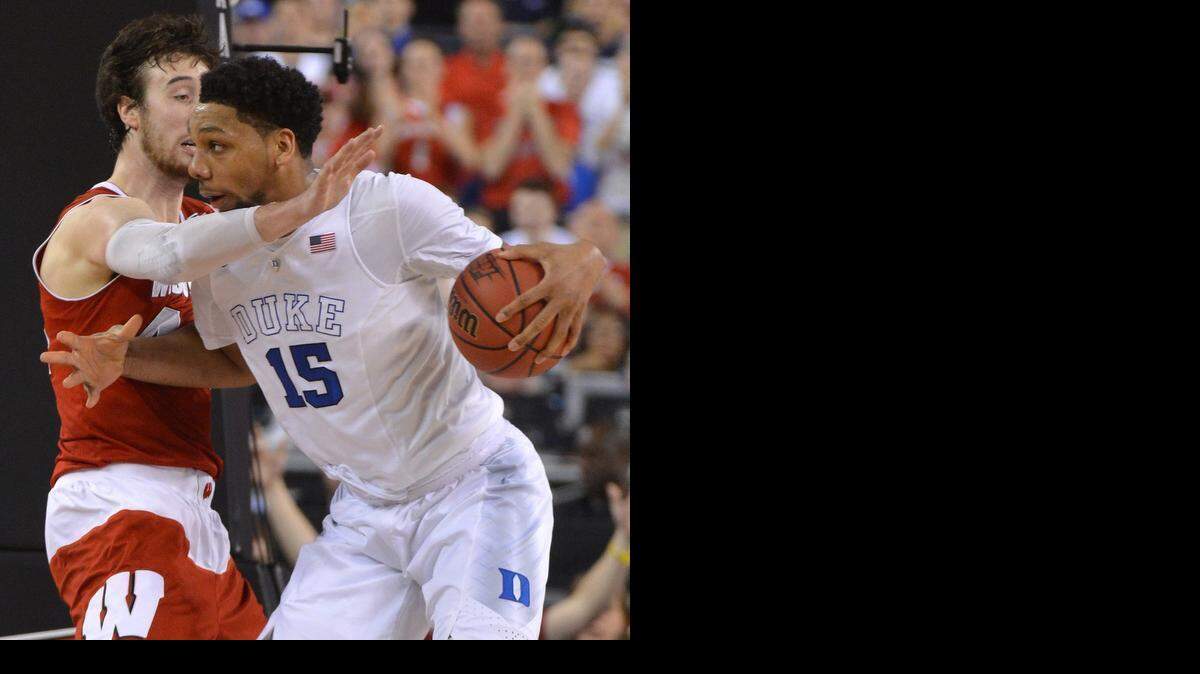 
Duke's Jahlil Okafor (15) drives against Wisconsin's Frank Kaminsky (44) during the first half in the 2015 Division I Men's Basketball Championship game at Lucas Oil Stadium in Indianapolis.
