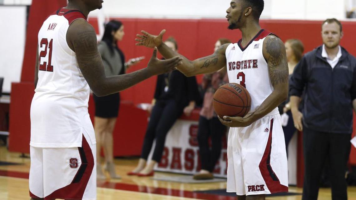 
N.C. State's Terry Henderson (3), right, high-fives BeeJay Anya (21) while shooting the ball before the N.C. State basketball media day at Dail Basketball Center in Raleigh Thursday, Oct. 1, 2015.

