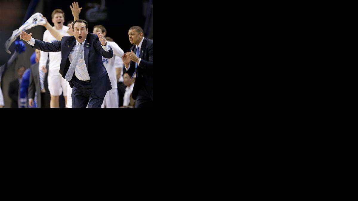Duke head coach Mike Krzyzewski and the bench react after a play against San Diego State during the first half of an NCAA tournament college basketball game in the Round of 32 in Charlotte, N.C., Sunday, March 22, 2015.