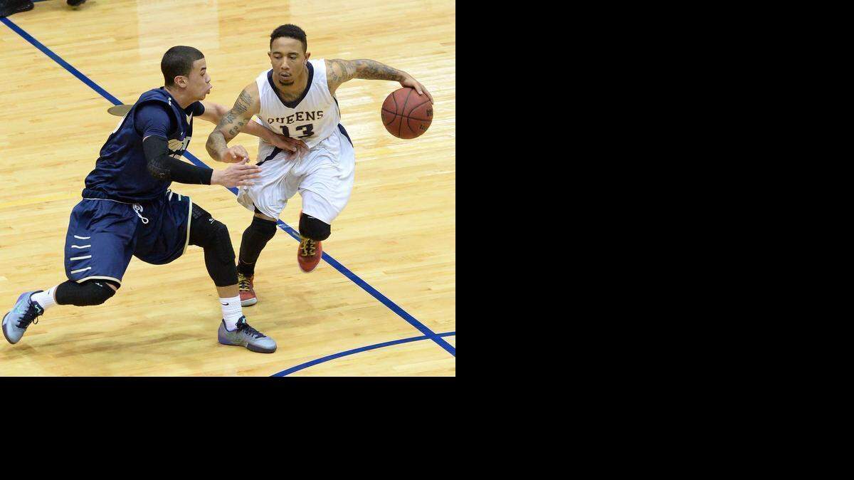 
 Queens University guard Kendall Jones (right), drives the ball to the basket against Wingate University's Zerig Lolar (left), during the quarterfinals of the South Atlantic Conference men's basketball tournament played at Curry Arena, March. 04,2015.
