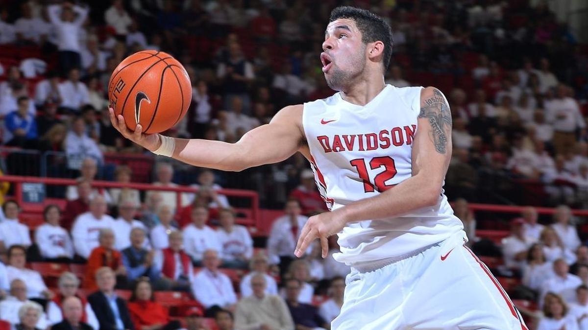 Davidson’s Jack Gibbs (12) of Davidson drives to score two of his career-high 43 points against UMass at the John M. Belk Arena on Saturday. Gibbs would hit the 1,000-point career mark as Davidson won 86-74.