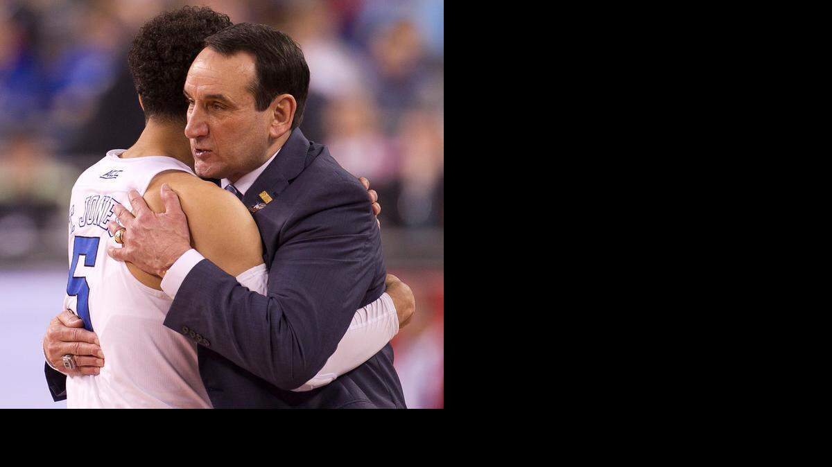 
Duke coach Mike Krzyzewski embraces Tyus Jones (5) in the closing minutes against Michigan State in the NCAA semifinals, Saturday April 4, 2015 at the Lucas Oil Stadium in Indianapolis.
