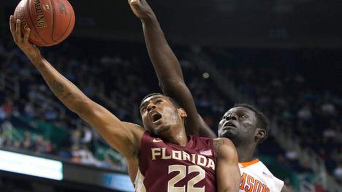 
Florida States Xavier Rathan-Mayes (22) drives to the basket by Clemsons Sidy Djitte (50) during the first half of their second round ACC Tournament game on Wednesday, March 11, 2015 at the Greensboro Coliseum in Greensboro, N.C. 
