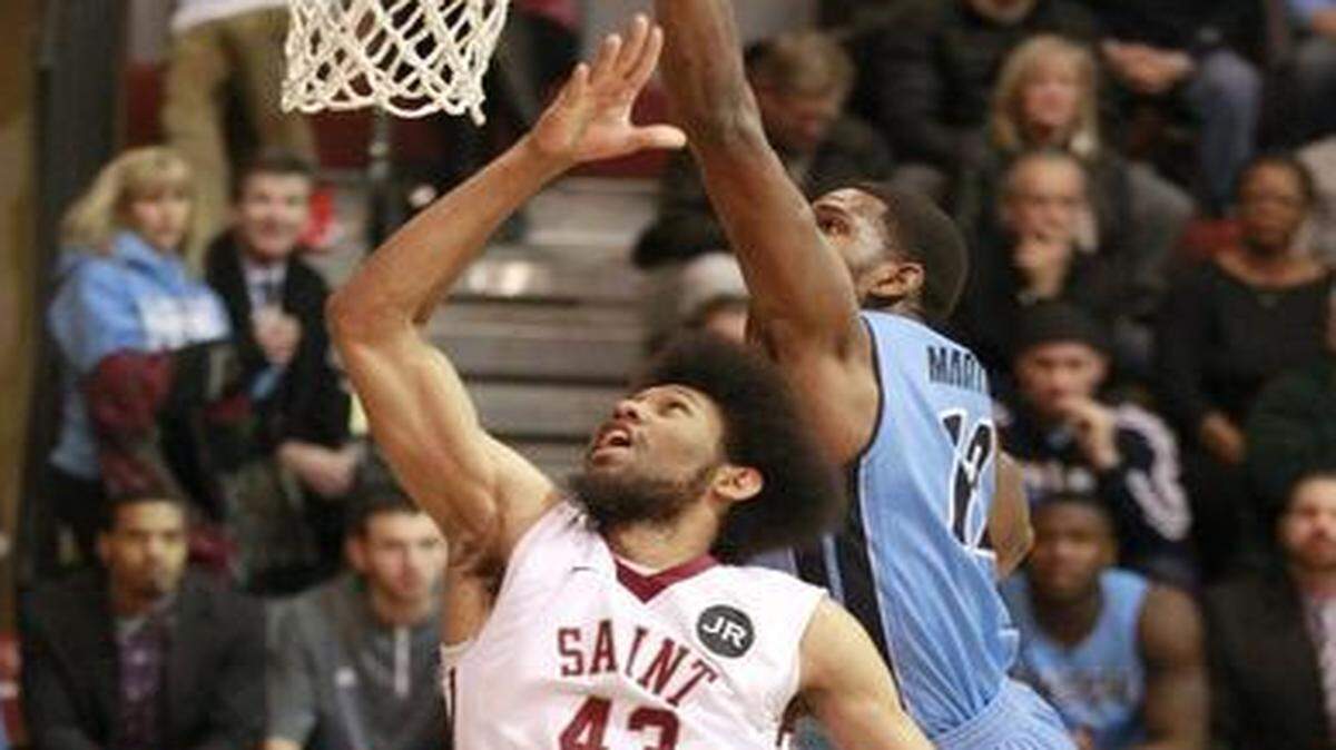
Saint Joseph's DeAndre' Bembry, left, scores against Rhode Island's Hassan Martin during the first half of an NCAA college basketball game Wednesday, Feb. 11, 2015, in Philadelphia. 
