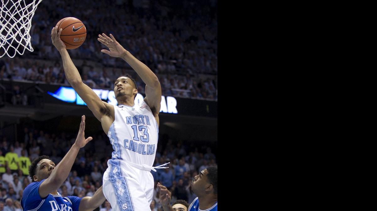 
North Carolina’s J.P. Tokoto (13) drives to the basket in front of Duke’s Jahlil Okafor (15) during their March 7 game  at the Smith Center in Chapel Hill.
