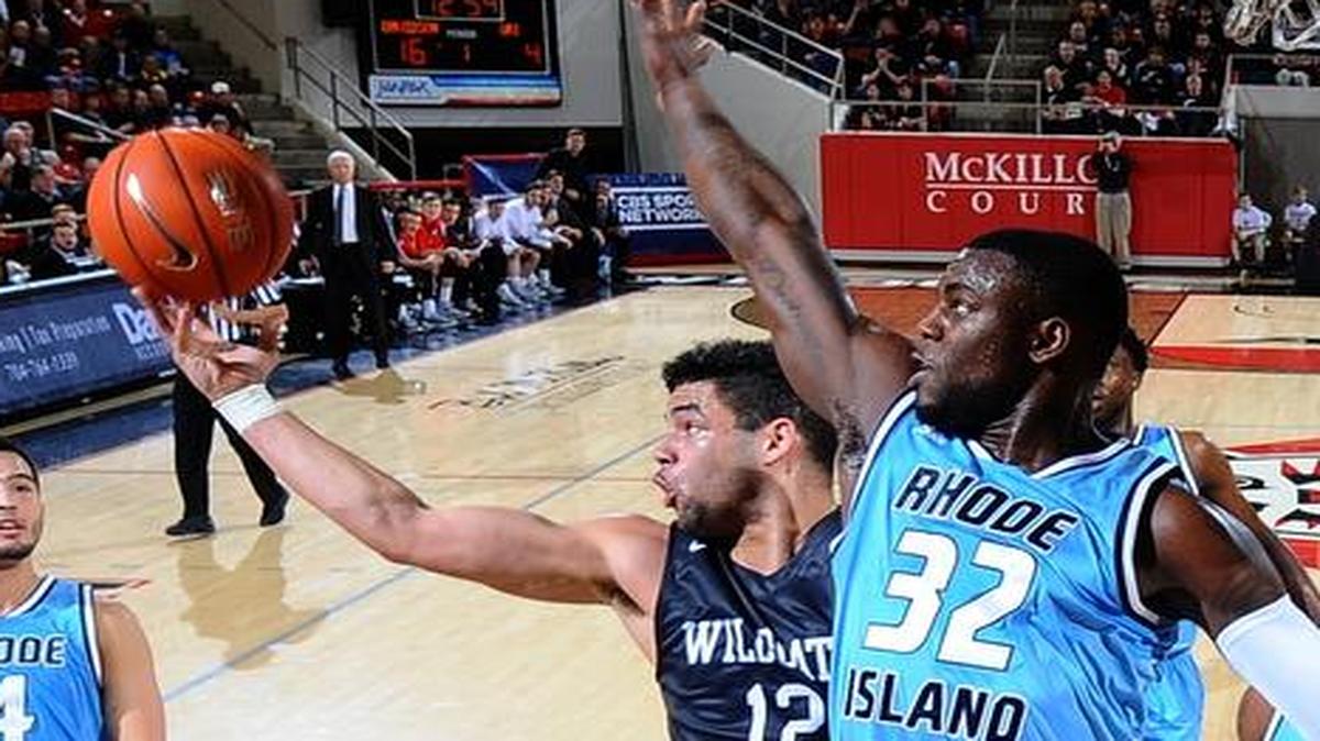 Jack Gibbs (12) of Davidson scoops a shot over Jared Terrell (32) of Rhode Island to score two of his 17 points late in the first half of A-10 men's basketball action at the John M. Belk Arena on Tuesday, February 23, 2016 in Davidson, North Carolina. Davidson won 65-54.