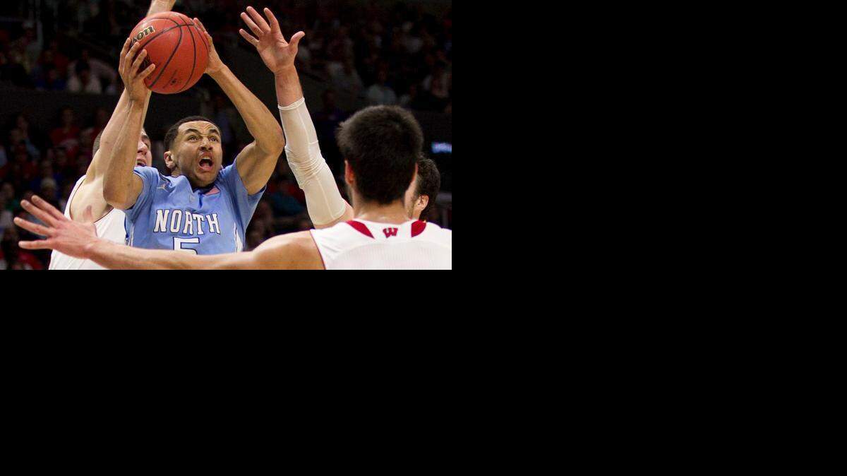 
North Carolina’s Marcus Paige drives to the basket against Wisconsin’s Duje Dukan in the NCAA West Region semifinals on Thursday, March 26, 2015 at the Staples Center in Los Angeles.
