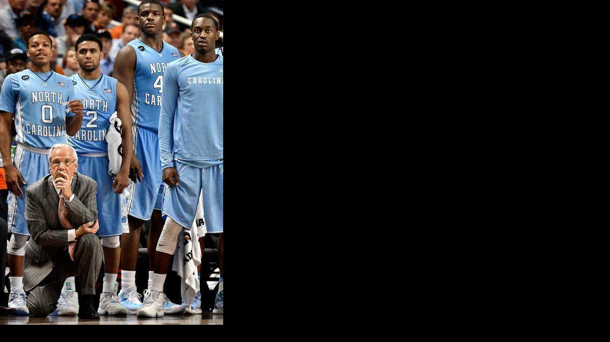 
North Carolina head coach Roy Williams and the bench watch in the closing minute of the game as the Tar Heels maintain their lead and defeat Louisville 70-60 during ACC tournament quarterfinal action March 12 at the Greensboro Coliseum.
