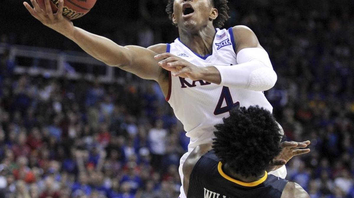 Raleigh native Devonte’ Graham (4), a sophomore, averages 11.7 points this season for the Kansas Jayhawks, the No. 1 overall seed in the NCAA tournament.