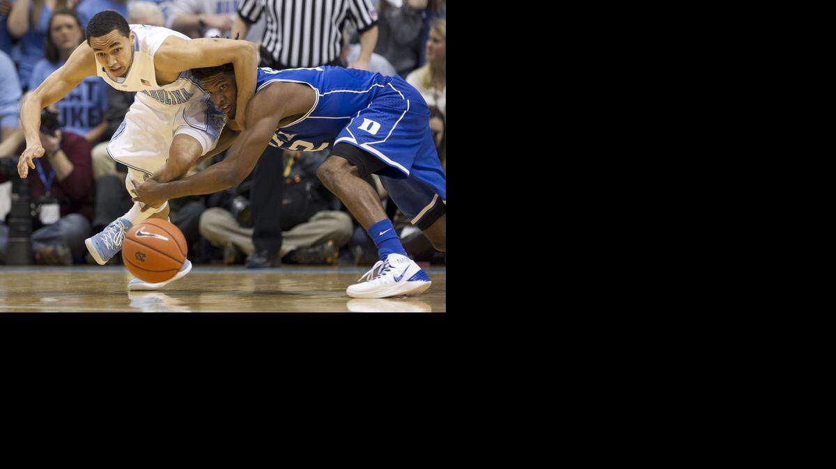 North Carolina’s Marcus Paige (5) and Duke’s Justise Winslow (12) battle for a loose ball during the first half on Saturday, March 7, 2015 at the Smith Center in Chapel Hill, N.C.
