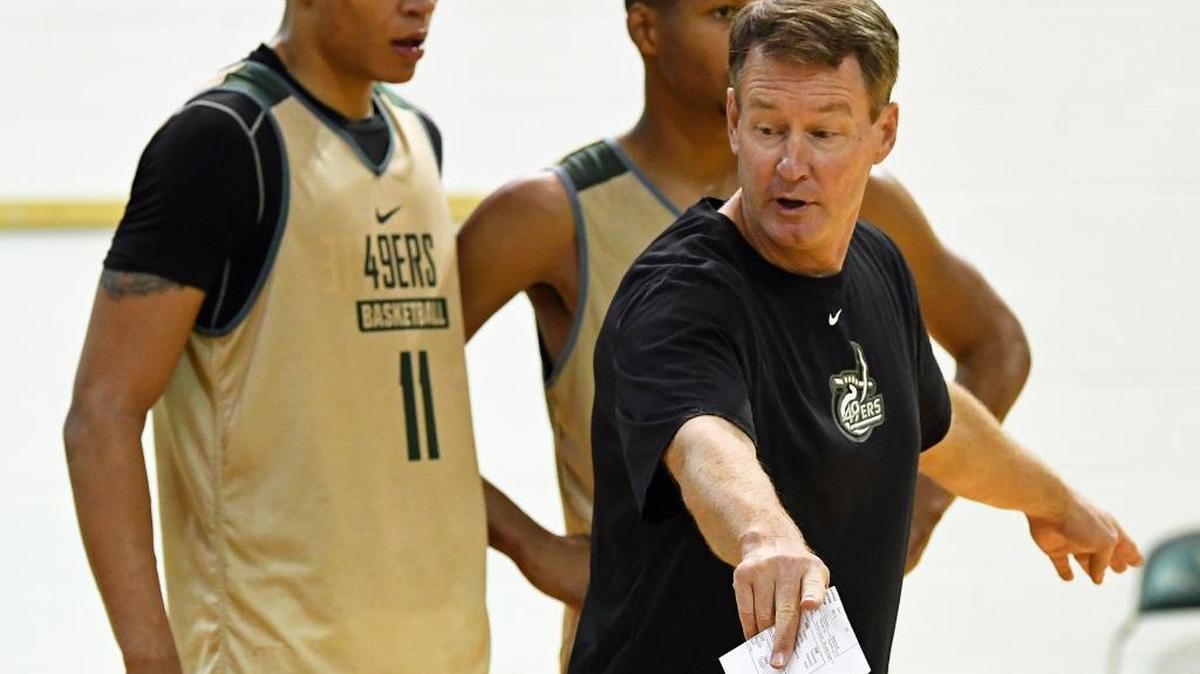 Charlotte men’s basketball coach Mark Price (right) works with freshmen Najee Garvin (left) and Quentin Jackson during the 49ers’ practice Tuesday afternoon.