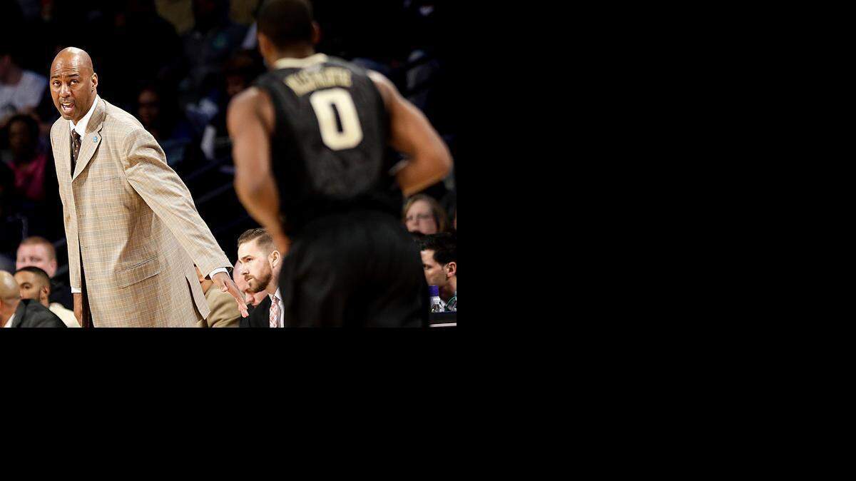 
Wake Forest head coach Danny Manning, left, talks to Codi Miller-McIntyre as he runs down the court in the second half of an NCAA college basketball game against Georgia Tech, Saturday, Feb. 7, 2015, in Atlanta. 
