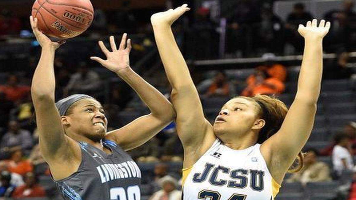 
Livingstone College's Carrie Blunt (30),left, shoots the ball against Johnson C. Smith University's Amena Brent (34)(right), to the basket during the second round of the CIAA women's tournament, Feb 25,2015, at Time Warner Cable Arena. Livingstone College defeated Johnson C. Smith University 50-43.
