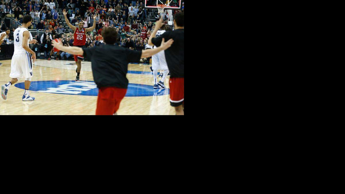 
N.C. State's Ralston Turner (22) celebrates the Wolfpack’s 71-68 victory over No. 1 seed Villanova in the NCAA men's basketball tournament at the Consol Energy Center in Pittsburgh, Pa., Saturday, March 21, 2015.
