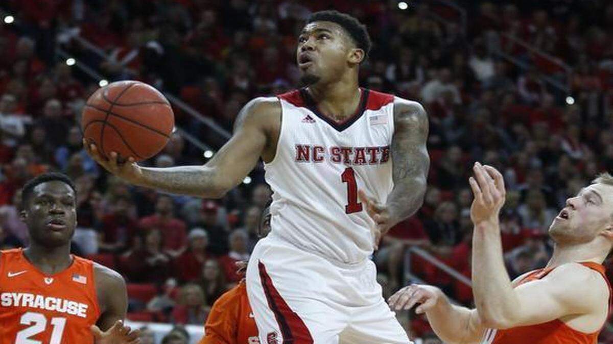 
N.C. State's Trevor Lacey drives to the basket past Syracuse's Trevor Cooney, right, during the first half at PNC Arena in Raleigh.
