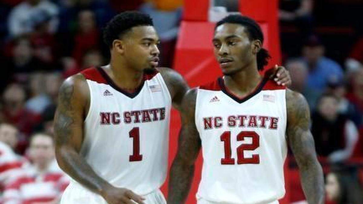 
N.C. State's Trevor Lacey (1), left, talks with Cat Barber (12) during the second half of N.C. State's 83-72 victory over Tennessee at PNC Arena in Raleigh, N.C., Wednesday, Dec. 17, 2014. 
