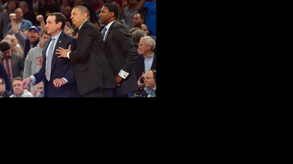 
Duke coach Mike Krzyzewski watches in the closing seconds with assistant Jeff Capel (middle) and Nate James as Duke beat St. John's 77-68 as giving Krzyzewski his 1,000th career win. 
