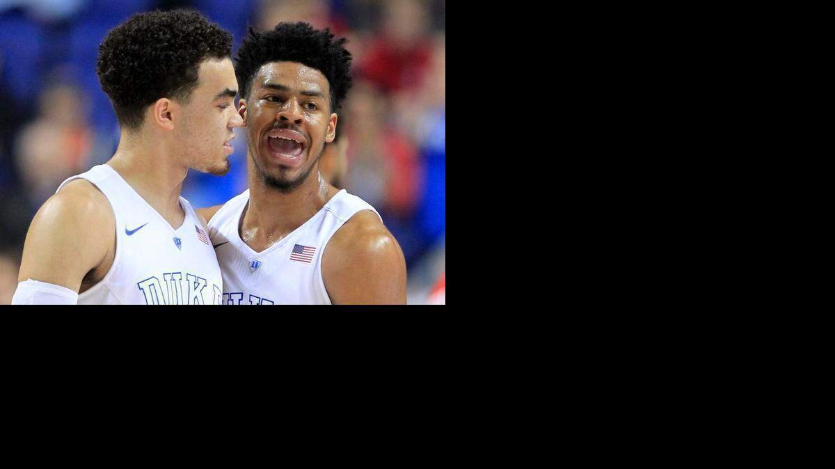 

Duke’s Tyus Jones, left, and Quinn Cook talk to each other as they come back to the huddle during a timeout against N.C. State in the quarterfinals of the 2015 New York Life ACC Tournament at the Greensboro Coliseum in Greensboro on March 12, 2015.

