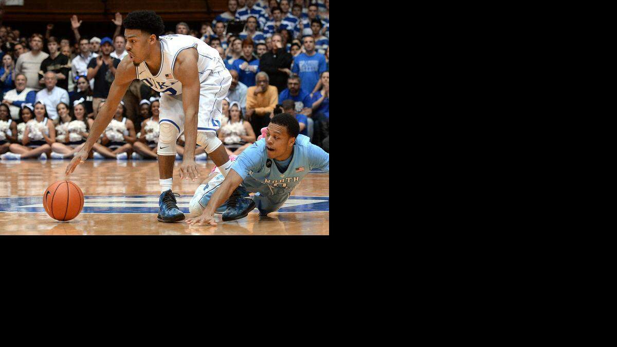 
Duke guard Quinn Cook  keeps the ball away from North Carolina guard Nate Britt  near the end of Duke’s  victory over UNC.
