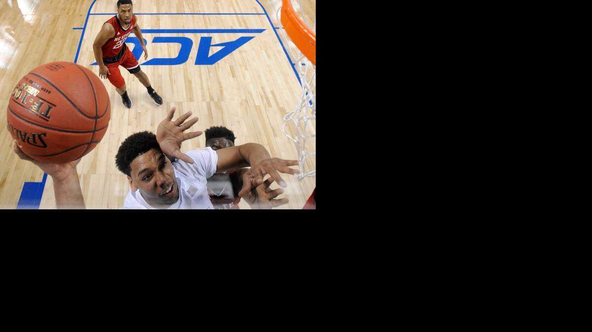 
Duke's Jahlil Okafor drives to the basket against N.C. State's Abdul-Malik Abu during the quarterfinals of the ACC Basketball Tournament at Greensboro Coliseum on Thursday, March 12, 2015 in Greensboro.
