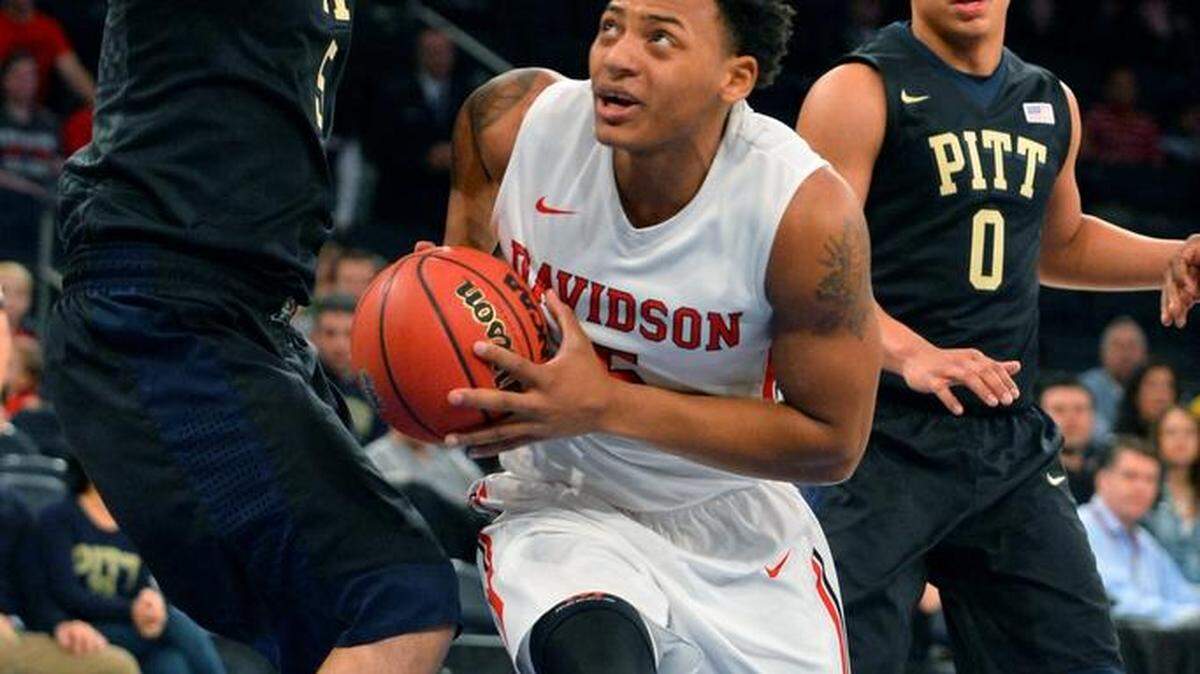 Jordan Barham (5) of Davidson drives and scores two of his five points against Pittsburgh's Rafael Maia (5) during the first half of the Gotham Classic at Madison Square Garden on Sunday in New York. Davidson lost 94-69.