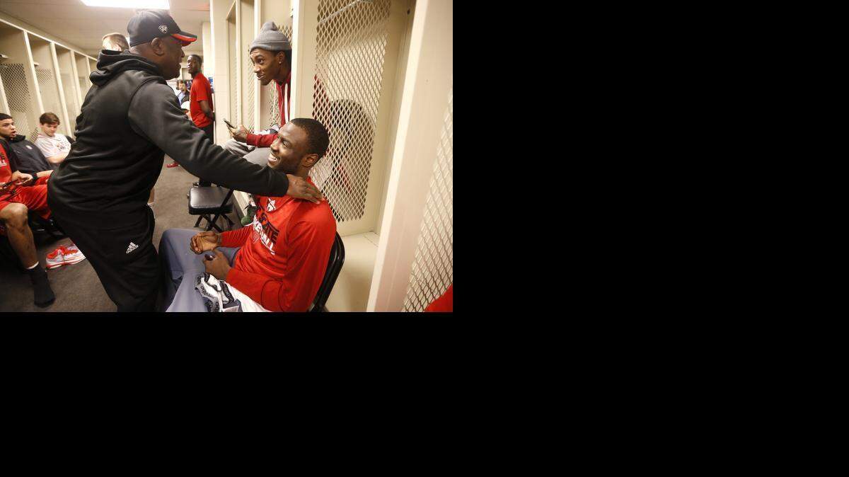
N.C. State Director of Player Development Dereck Whittenburg jokes with Desmond Lee, right, and Cat Barber as the Wolfpack get ready to practice at the Consol Energy Center in Pittsburgh, Pa. Friday, March 20, 2015. The Wolfpack will face Villanova Saturday in the third round of the NCAA Division I Men's Basketball Tournament. 
