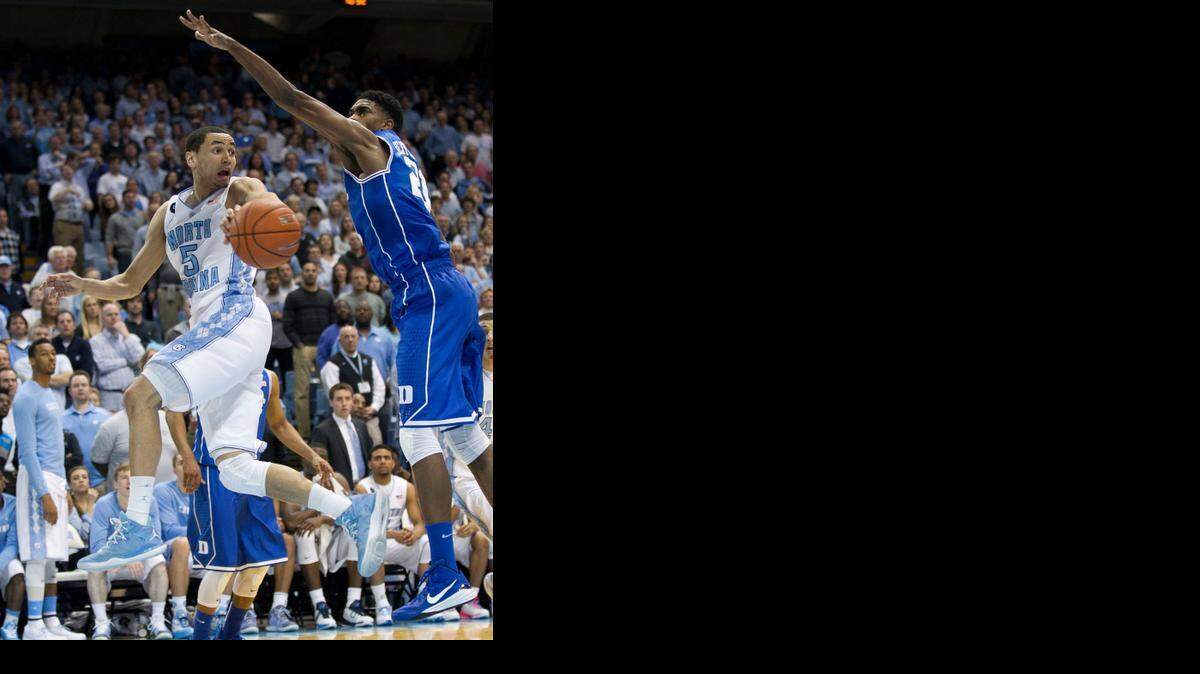 
North Carolina’s Marcus Paige drives against Duke’s Amile Jefferson in the closing minutes of play on Saturday at the Smith Center in Chapel Hill.
