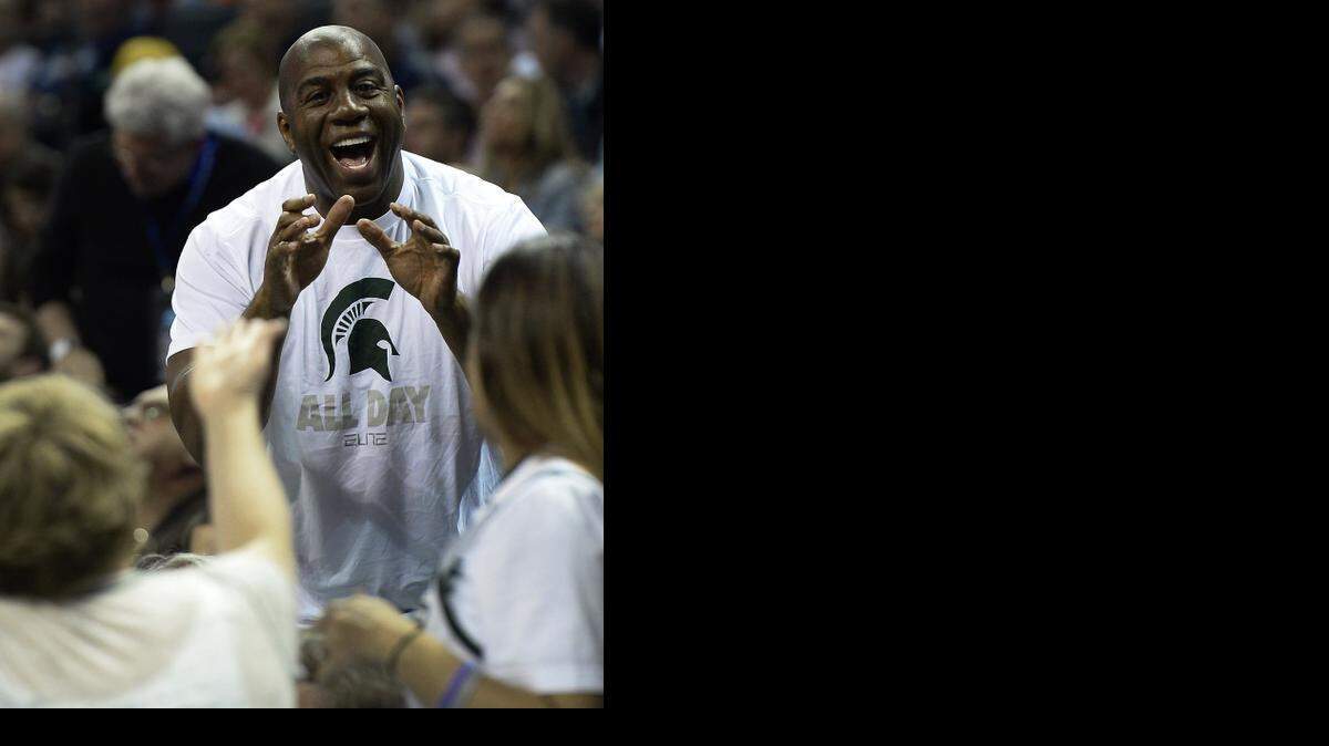 
Former Michigan State and NBA great Magic Johnson sat in the stands with Michigan State fans during Friday’s NCAA tournament game against Georgia at Time Warner Cable Arena. During halftime, he gladly posed for pictures. 
