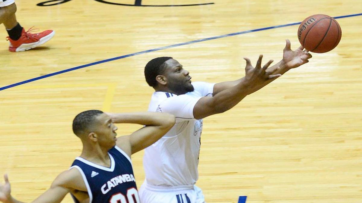 Queens University's Sean Morgan on right, reaches for a loose ball against Catawba College's Jeremy McLaughlin on left, during Wednesday night's game played at Queens University of Charlotte Levine Center Jan. 06 ,2016.