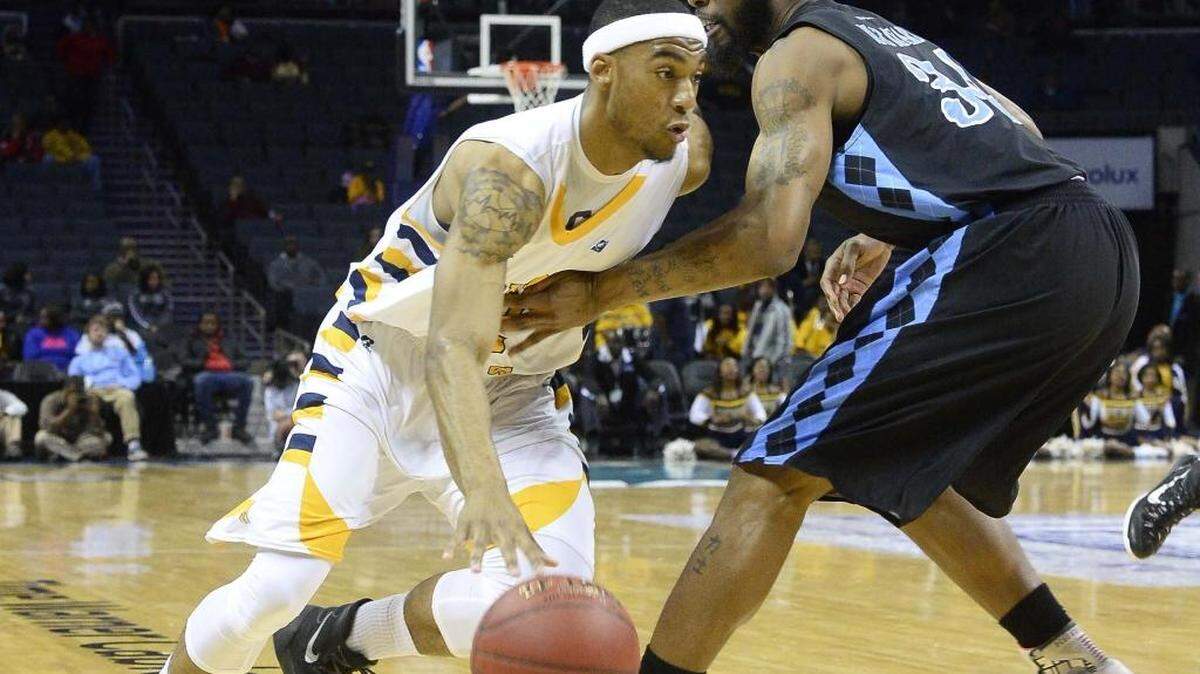 Johsnon C. Smith University's guard Diondre Pratt on left, drives the ball to the basket against Livingstone College's Cordero Holt on right, during Thursday's quarterfinal CIAA basketball game.