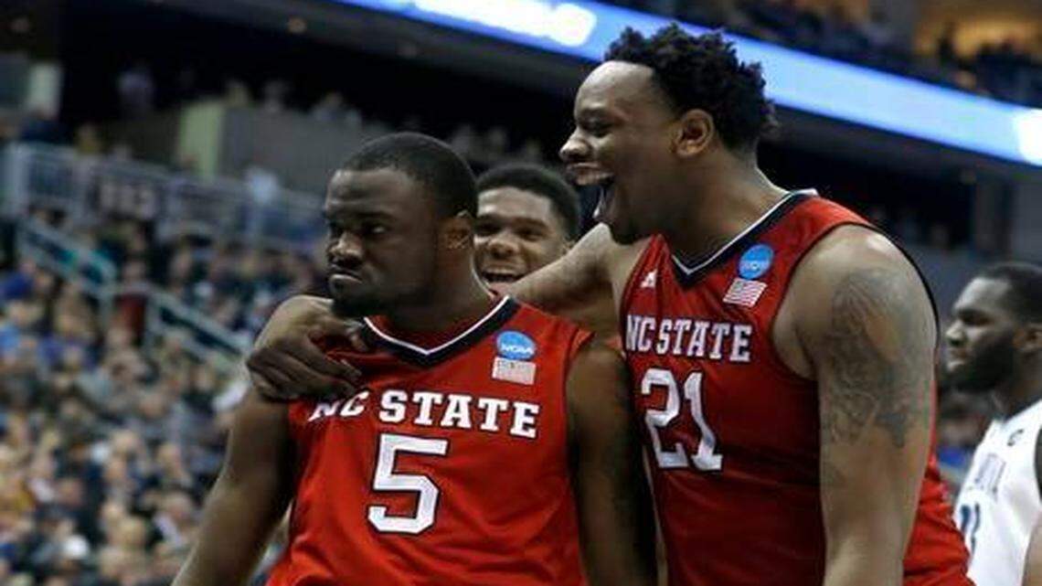 
N.C. State’s BeeJay Anya, right, congratulates Desmond Lee after Lee made a basket while being fouled during the second half of N.C. State’s 71-68 victory against Villanova in the third round of the NCAA tournament at the Consol Energy Center in Pittsburgh on Saturday.
