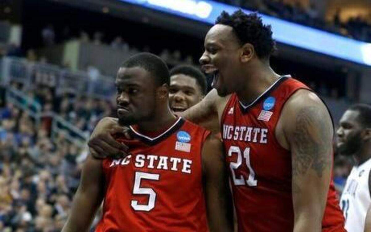 
N.C. State’s BeeJay Anya, right, congratulates Desmond Lee after Lee made a basket while being fouled during the second half of N.C. State’s 71-68 victory against Villanova in the third round of the NCAA tournament at the Consol Energy Center in Pittsburgh on Saturday.
