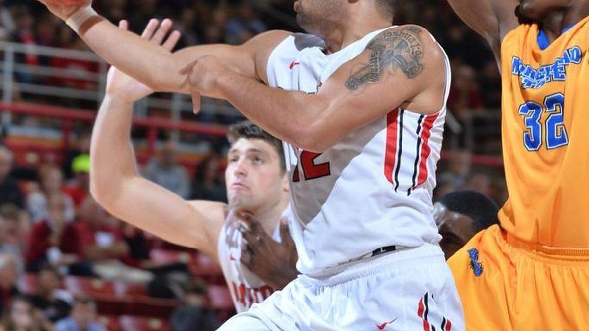 Jack Gibbs (12) of Davidson drives past Brent Arrington (32) of Morehead State to score in the first half of Wednesday’s Gotham Classic game at John M. Belk Arena. Gibbs tied his career high with 41 points as Davidson won 81-77.