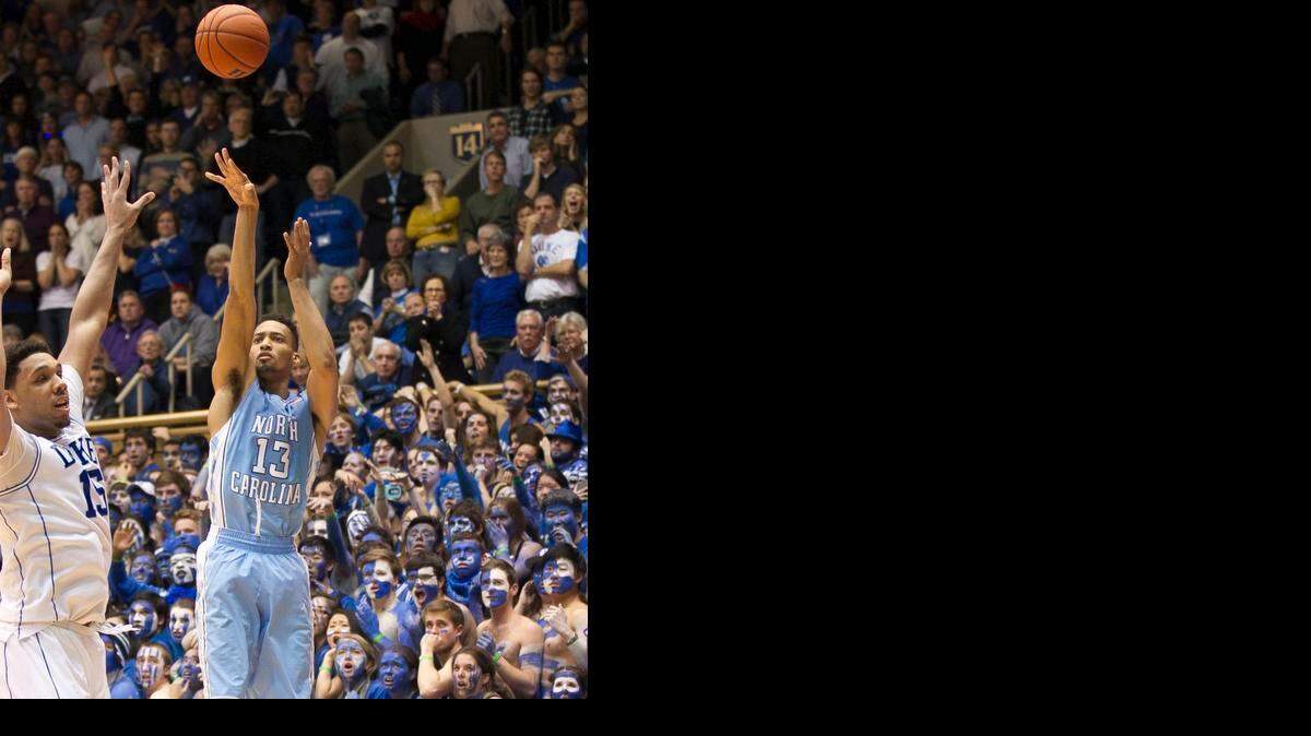 
With the Tar Heels down 91-89 in overtime, North Carolina’s J.P. Tokoto takes a jump shot over Duke’s Jahlil Okafor with 11 seconds to play in overtime on Wednesday at Cameron Indoor Stadium.
