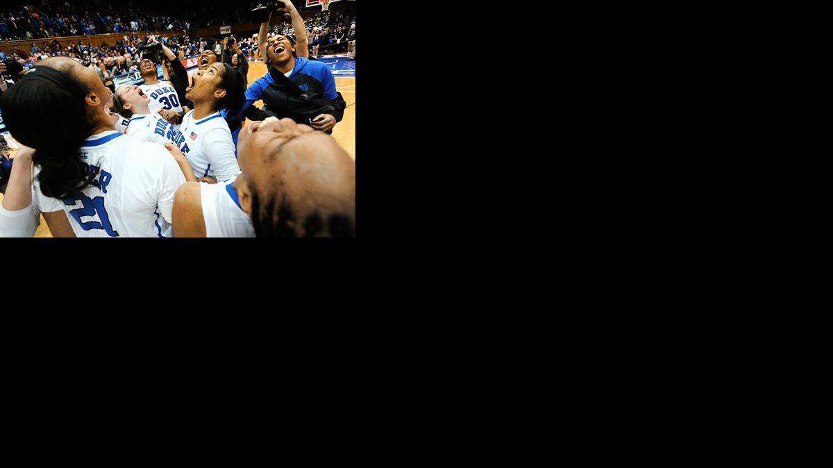 Duke women's basketball players, including Amber Henson (30), Jenna Frush (35), Ka'lia Johnson (14), react after defeating North Carolina 81-80 on Sunday, March 1, 2015 at Cameron Indoor Stadium in Durham, N.C.