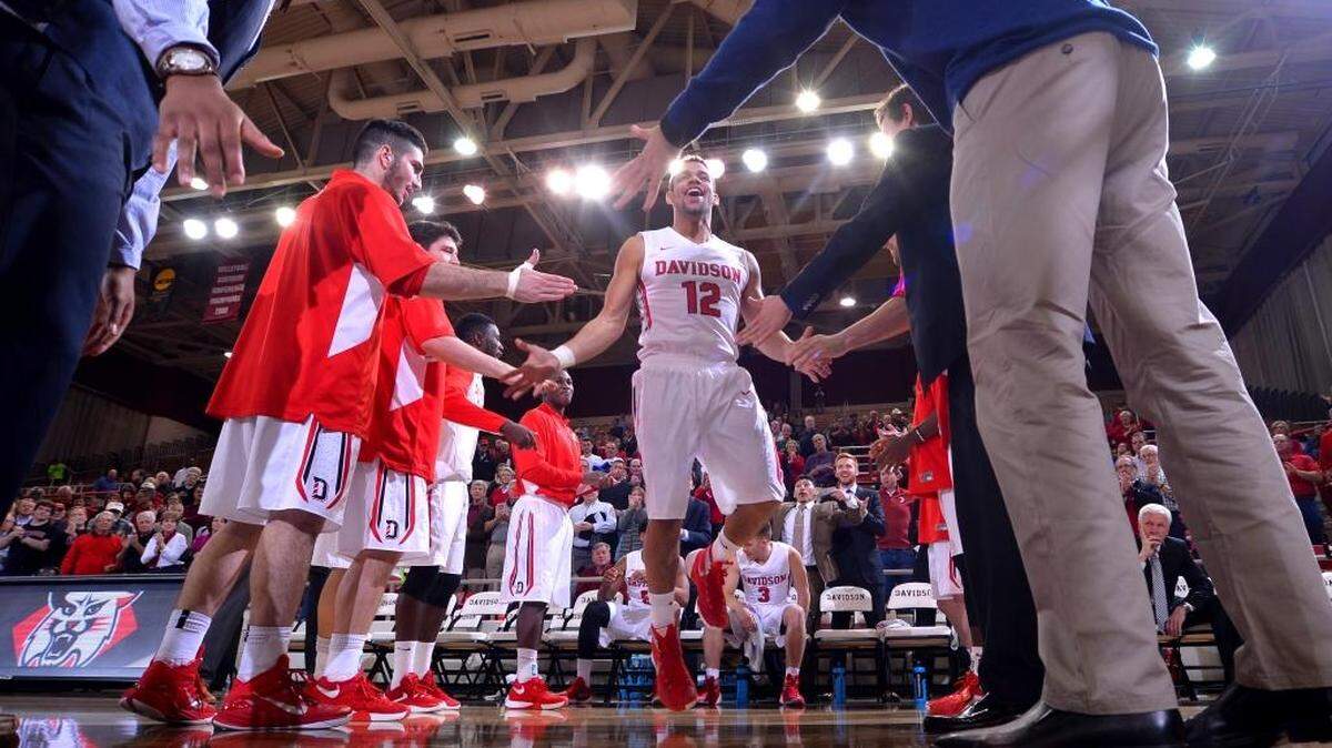 Davidson’s Jack Gibbs (12) greets his Wildcat teammates before Wednesday’s 96-86 win over Eastern Washington in the the Gotham Classic at John M. Belk Arena. The Davidson guard scored 37 points and also had six assists and two steals.