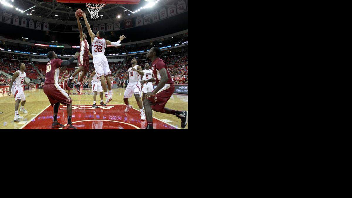 
N.C. State's Kyle Washington (32) blocks the shot of Florida State's Ian Miller (30) in N.C. State's 74-70 victory over Florida State at PNC Arena in Raleigh, Jan. 29, 2014.
