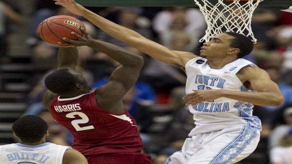 
North Carolina’s Brice Johnson (11) blocks a shot by Arkansas’ Alandise Harris (2) during the first half in the third round of the NCAA Tournament on Saturday at the Jacksonville Veterans Memorial Arena in Jacksonville, Fla.
