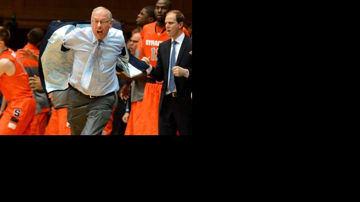 
Syracuse head coach Jim Boeheim charges the floor after a charge is called on Syracuse forward C.J. Fair in the closing seconds of a matchup again Duke on Feb. 22, 2014. On Friday, the NCAA punished the Orange basketball program and  Boeheim for self-reported violations that dated to 2001. 
