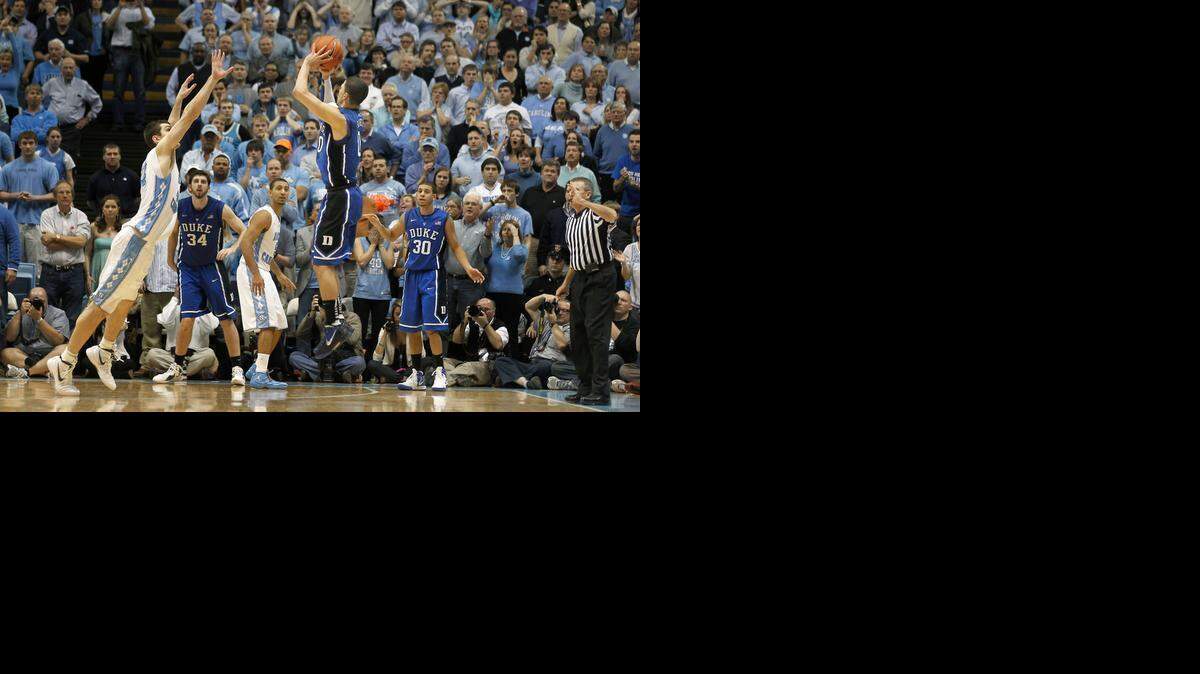 
Duke guard Austin Rivers (0) launches a three pointer as UNC forward Tyler Zeller (44) attempts to defend to win the game 85-84 at the Smith Center on Feb. 8, 2012.
