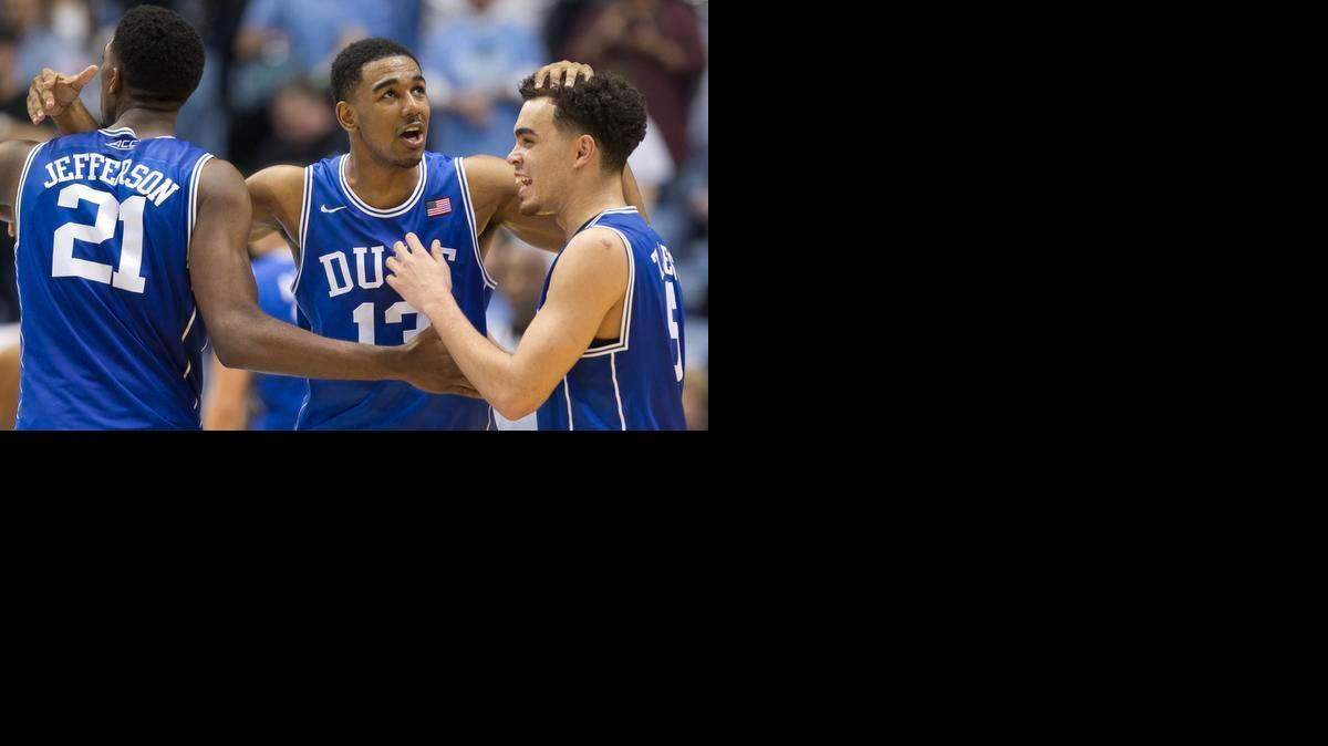 
Duke’s Amile Jefferson (21), Matt Jones (13) and Tyus Jones (5) celebrate their victory over North Carolina on Saturday, March 7, 2015 at the Smith Center in Chapel Hill.
