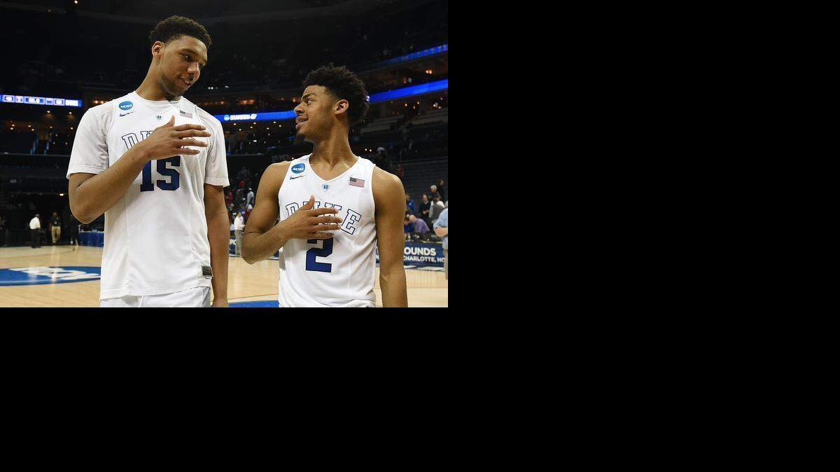 
Duke center Jahlil Okafor (15) and teammate guard Quinn Cook (2) tap their hearts as they leave the floor afeter the Blue Devils beat San Diego State68-49 at the Time-Warner Cable Arena in Charlotte to advance to the NCAA Sweet 16 in Houston.
